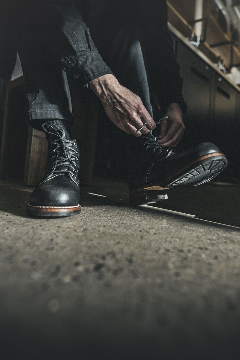 Stylish person leaning against doorway